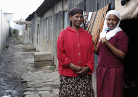 Hawa and Musra Mohammed outside their single-room home in Mukuru informal settlement, Nairobi, Kenya, March 2014. Credit: Sam Tarling
